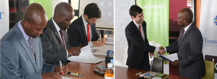 Men signing documents and shaking hands, signifying an agreement or partnership